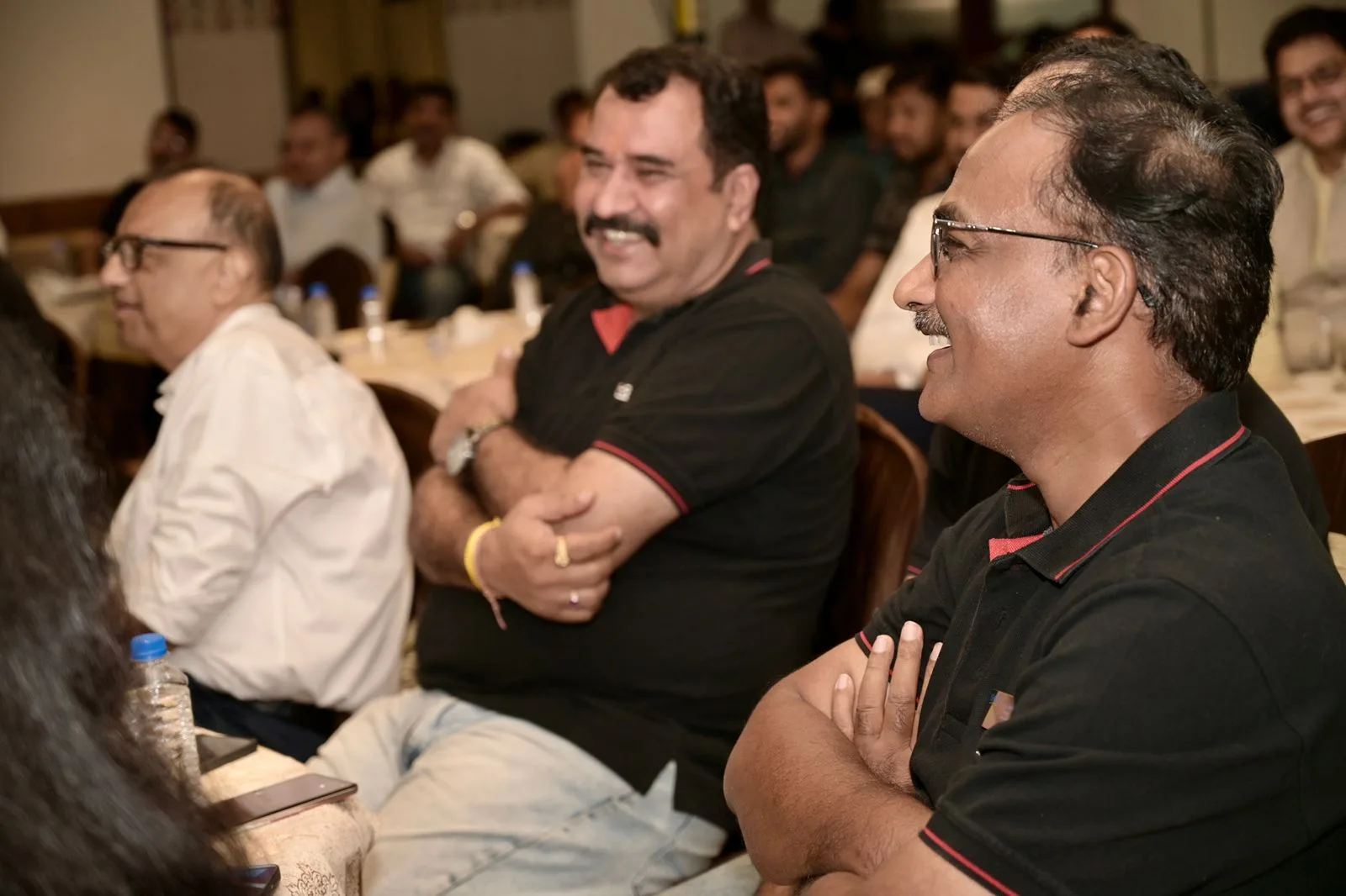 Corporate quiz players laughing during a round